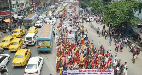  ?? — AFP ?? Tea garden workers march during a protest rally to demand the implementa­tion of a minimum wages in Kolkata on Thursday.