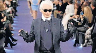  ?? Picture: REUTERS/BENOIT TESSIER ?? REIGNING SUPREME: German designer Karl Lagerfeld appears at the end of his haute couture Spring-Summer 2012 fashion show for French fashion house Chanel in Paris