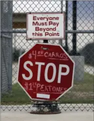  ?? THE ASSOCIATED PRESS ?? Signs mark the entrance to a border crossing in Los Ebanos, Texas. The idea of a concrete wall spanning the entire 1,954-mile southwest frontier collides head-on with multiple realities, like a looping Rio Grande, fierce local resistance and cost.