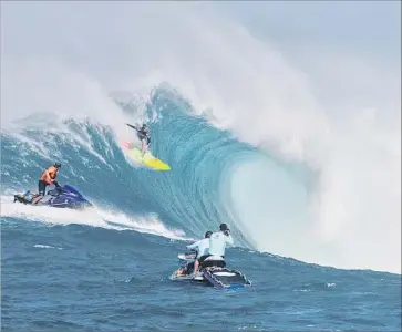  ?? Brian Bielmann AFP/Getty Images ?? THIS YEAR’S Mavericks big wave contest would’ve included a women’s heat for the first time, but the event was canceled because of financial troubles. Above, surfer Paige Alms rides a big wave off Maui in November.