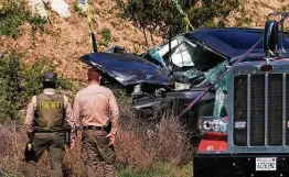  ?? Ringo H.W. Chiu / Associated Press ?? A crane is used to lift Tiger Woods’ vehicle from its resting spot after an accident Tuesday in which it rolled over several times.