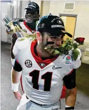  ?? CURTIS COMPTON / CCOMPTON@AJC.COM ?? Georgia QB Jake Fromm leaves the field with a rose in his teeth after beating Oklahoma 54-48 in two overtimes at the Rose Bowl.