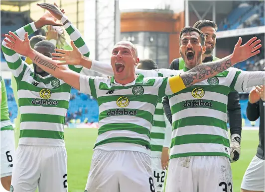  ??  ?? Celtic captain Scott Brown and his team-mates celebrate after beating Rangers 2-0 at Ibrox last Sunday