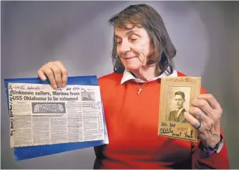  ?? JIM THOMPSON/JOURNAL ?? Racheli Bauer holds a photo of her uncle, Dante Sylvester Tini, who was killed at age 18 on the USS Oklahoma during the Dec. 7, 1941, attack on Pearl Harbor.