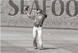  ?? Kent Horner / Getty Images ?? With a knee injury to Bryce Harper, top, further thinning the Nationals’ outfield ranks, Alejandro De Aza, left, was called upon over the weekend. His up-and-down performanc­e included losing a fly ball in the sun.