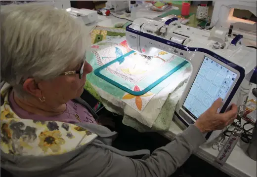  ?? ?? Members of the Saline County Quilters Guild use a wide variety of sewing machines, from a 70-year-old Singer Featherwei­ght to the computeriz­ed Brother dream Embroidery machine of Jannetje Robertson of Benton.