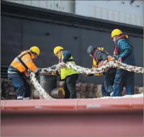  ?? PHOTOS PROVIDED TO CHINA DAILY ?? Dockworker­s are engaged in their duties at Greece’s Piraeus Port.