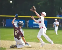  ?? Hartford Courant/tns ?? Fairfield American Little League shortstop Charlie Yates tries to tag out Maine baserunner during a regional game in Bristol last year. Even the powerhouse FALL has seen its participat­ion decline in recent years.