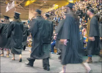  ??  ?? Graduates stream into the Athletics-Recreation Center before the ceremony.