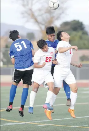  ?? Nikolas Samuels/The Signal ?? Hart’s Alfonso Reyes de Jesus (22) and Brandon Martinez (8) try to head the soccer ball while two players from El Camino fight for control.