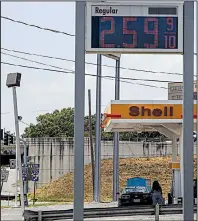  ?? Arkansas Democrat-Gazette/MITCHELL PE MASILUN ?? A motorist gets gas Saturday at the Shell station on Roosevelt Road and Interstate 30 in Little Rock. In Arkansas, the average price of a gallon of regular gasoline is 58 cents higher than it was a year ago.