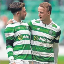  ??  ?? Leigh Griffiths (right) embraces Patrick Roberts at full time.