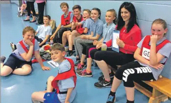  ??  ?? The Brodick pupils enjoy a rest between games with coach Anne Watts.