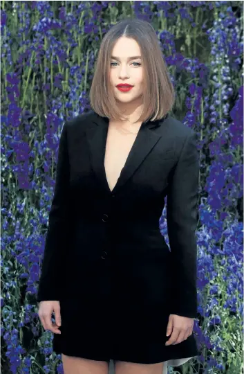  ?? THIBAULT CAMUS/THE ASSOCIATED PRESS FILE ?? British actress Emilia Clarke poses for photograph­ers prior to the start of the Christian Dior’s Spring-Summer 2016 ready-to-wear fashion collection in Paris, France, on Oct. 2, 2015.