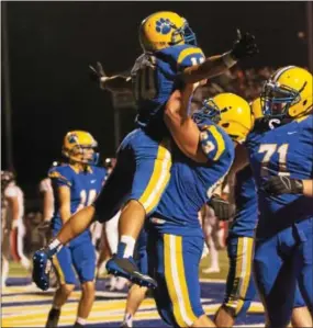  ?? MICHAEL REEVES — FOR DIGITAL FIRST MEDIA ?? Downingtow­n East running back Garvey Jonassaint (10) celebrates his touchdown with lineman Weston Menzie Friday night.