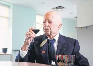  ?? RENE JOHNSTON TORONTO STAR ?? A.E. “Al” Stapleton is a veteran who was stationed in Italy during the Battle of Ortona. He’s drinking wine from a bottle gifted by the mayor of Ortona to commemorat­e Canada’s victory.