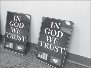  ?? Northwest Arkansas Democrat-Gazette/DAVE PEROZEK ?? Two of the framed “In God we trust” posters presented to Bentonvill­e School Board members at their Feb. 19 meeting are seen here. State Rep. Jim Dotson, R-Bentonvill­e, and Ray Brust, a representa­tive of American Legion Post 77, presented the posters to...