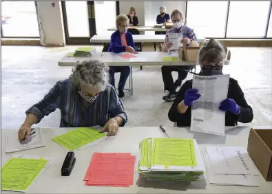  ?? (Arkansas Democrat-Gazette/Staton Breidentha­l) ?? Officials work Tuesday at the Pulaski County Election Commission in Little Rock to tabulate provisiona­l ballots cast during the Nov.
3 election.