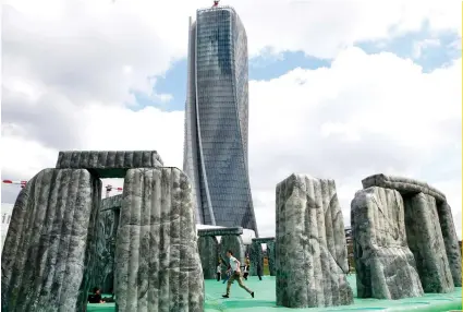  ?? AP FOTO ?? ART: A boy plays on an inflatable replica of the Neolithic site of Stonehenge titled “Sacrilege,” a work by British artists Jeremy Deller, currently on display at the Milan Art Week.