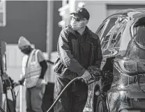  ?? David Paul Morris / Bloomberg ?? A man pumps fuel at a Chevron gas station in San Francisco. Gasoline has seen some of the biggest price hikes recently, up 75 cents a gallon over a year ago.