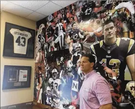  ?? JOHN ZENO/AP ?? Former Auburn football coach Gene Chizik poses for a photo Tuesday in a section dedicated to Philip Lutzenkirc­hen, a popular Auburn tight end who died in a 2014 car crash, at one of Chizik’s three Louie’s catfish and wings restaurant­s in Auburn, Alabama.