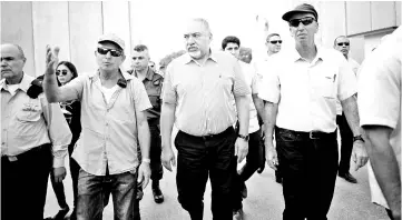  ??  ?? Lieberman (second right) visits Gaza’s Kerem Shalom crossing, the strip’s main commercial border terminal. — Reuters photo