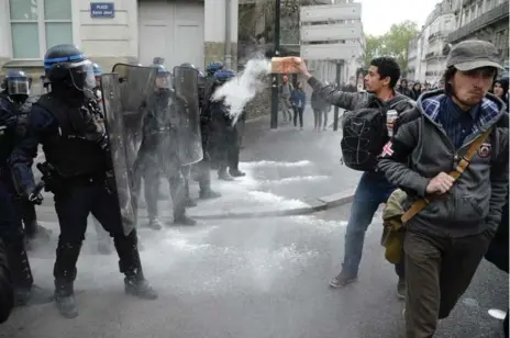  ?? JEAN-SEBASTIEN EVRARD/AFP/GETTY IMAGES ?? Youths protest both Marine Le Pen and Emmanuel Macron, both of whom qualified for the May 7 run-off in France’s two-stage presidenti­al election.