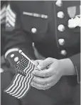  ?? ALEX WONG, GETTY IMAGES ?? A Marine at a 2014 naturaliza­tion service in Triangle, Va.