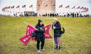 ?? SAMUEL CORUM/GETTY ?? Supporters of then-President Donald Trump gather on the lawn around the base of the Washington Monument on Jan. 6. A riot later in the day at the U.S. Capitol would leave five people dead.