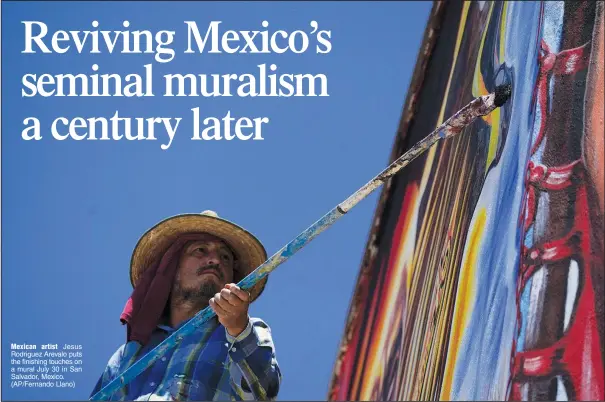  ?? ?? Mexican artist Jesus Rodriguez Arevalo puts the finishing touches on a mural July 30 in San Salvador, Mexico. (AP/Fernando Llano)