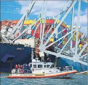  ?? REUTERS ?? A Coast Guard boat carrying senior officers to assess the Francis Scott Key Bridge collapse passes the Singapore-flagged cargo ship Dali in Baltimore, Maryland, US, on Friday.