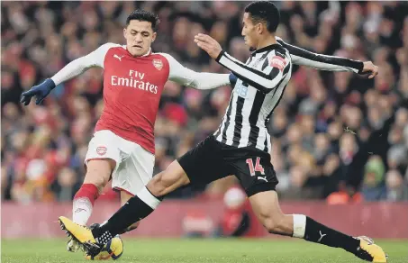  ??  ?? Newcastle midfielder Isaac Hayden blocks an effort from Arsenal dangerman Alexis Sanchez on Saturday.