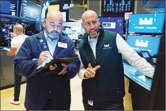  ?? (AP) ?? In this file photo, trader Fred DeMarco, left, and specialist Meric Greenbaum work on the floor of the New York Stock Exchange. Stocks wobbled in midday trading on Wall Street Thursday, a day after approachin­g record highs set this summer.