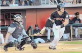  ?? JIM THOMPSON/JOURNAL ?? Albuquerqu­e’s Mike Tauchman, right, and El Paso catcher Tony Cruz watch Tauchman’s single during the host Isotopes’ game on Saturday.