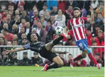  ?? CESAR MANSO/AFP/GETTY IMAGES ?? Real Madrid’s Danilo, left, intercepts a ball intended for Atletico Madrid’s Yannick Ferreira Carrasco, Wednesday.