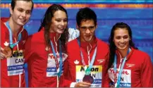  ?? The Canadian Press ?? Canada’s Yuri Kisil, Penny Oleksiak, Richard Funk and Kylie Jacqueline Masse, from left, show off their bronze medals for the mixed medley relay event during the World Aquatics Championsh­ips in Budapest, Wednesday.