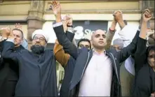  ?? Jeff J. Mitchell/Getty Images ?? Multi-cultural religious leaders hold a vigil Wednesday in St. Ann’s Square in Manchester, England.