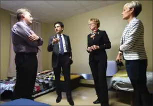  ?? PETER LEE, RECORD STAFF ?? House of Friendship executive director John Neufeld, left, Ontario Attorney General Yasir Naqvi, Kitchener Centre MPP Daiene Vernile and House of Friendship housing services manager Christine Stevanus view a room in the House of Friendship on Monday.