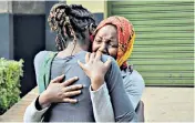  ??  ?? A distressed woman is hugged after identifyin­g victims’ bodies