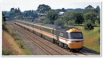  ?? JOHN CHALCRAFT. ?? The Western Region used surplus Standard Class cars to increase its seven-car rakes to eight. Led by 43026, the 1232 Swansea-Paddington passes the site of Badminton station on August 26 1991.