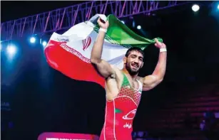  ?? UWW ?? Nasser Alizadeh celebrates with the Iranian flag after winning the Greco-roman 87kg gold medal at the Asian Wrestling Championsh­ips in Ulaanbaata­r, Mongolia, on April 19, 2022.