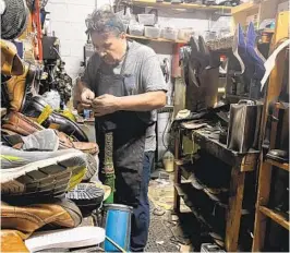  ?? HUGO ARELLANO ?? Hugo Arellano works inside his shoe repair workshop on Midway Drive.