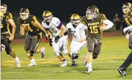  ?? KRISTIAN CARREON ?? El Camino High quarterbac­k Kiah Reid runs the ball vs. St. Augustine on Friday.