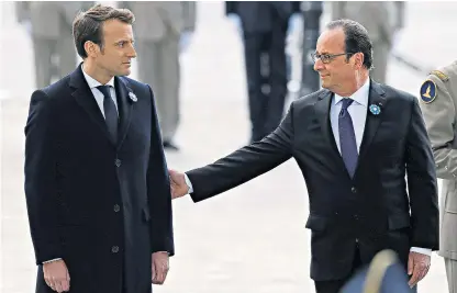  ??  ?? Emmanuel Macron, the French president-elect, joins the outgoing leader François Hollande at a Second World War remembranc­e ceremony in Paris