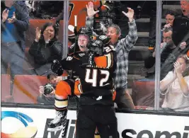  ?? Jae C. Hong ?? The Associated Press Anaheim’s Ondrej Kase celebrates his overtime goal with Josh Manson (42), which gave the Ducks a 4-3 victory over the Avalanche on Sunday in Anaheim, Calif.