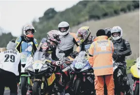  ?? ?? Discussion­s as the race halts during the Steve Henshaw Gold Cup meeting