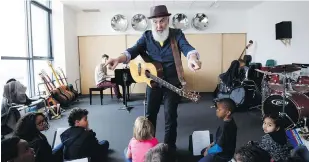  ??  ?? Fred Penner talks to children in his audience during a show at the Regent Park School of Music in Toronto this week.