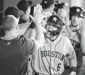  ?? John McCoy / Associated Press ?? Two weeks ago, Astros outfielder Jake Meyers (6) was in the minors. Now, he’s hit his first two career homers, including a grand slam, to help the Astros rally past the Angels and clinch a series victory.