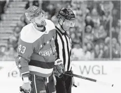  ?? WILL NEWTON/GETTY IMAGES ?? Capitals forward Tom Wilson is ejected after colliding with New Jersey forward Brett Seney in the second period Friday night at Capital One Arena.