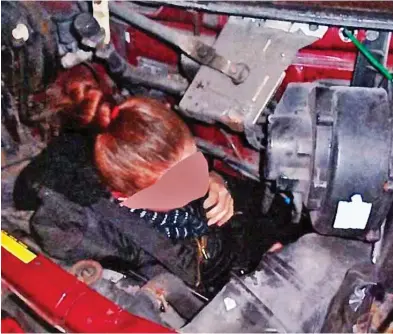  ??  ?? Stowaway: The Albanian woman, her features obscured, hides in the engine compartmen­t